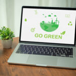 Stockphoto of a laptop that says Go Green and shows green symbols that relate to the environment