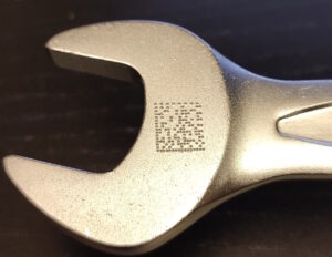Closeup of a datamatrix code dotpeened on a wrench